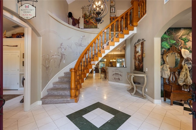 11450 Nellie Oaks Bnd, Clermont, FL 34711 - stairs featuring arched walkways, a towering ceiling, a chandelier, and tile patterned floors