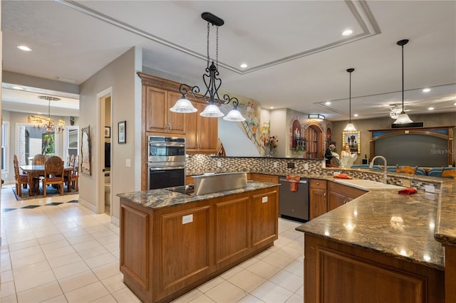 11450 Nellie Oaks Bnd, Clermont, FL 34711 - kitchen featuring appliances with stainless steel finishes, brown cabinets, a spacious island, light tile patterned floors, and tasteful backsplash