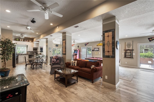 11450 Nellie Oaks Bnd, Clermont, FL 34711 - living room with ceiling fan, a textured ceiling, light wood-type flooring, and recessed lighting