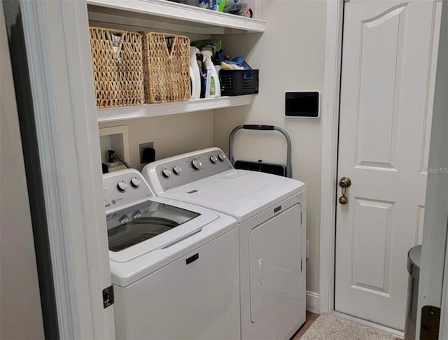 clothes washing area featuring independent washer and dryer and laundry area