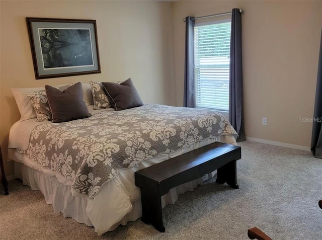 carpeted bedroom featuring baseboards
