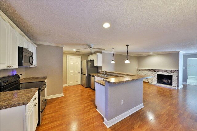 426 S Lakemont Ave, Winter Park, FL 32792 - kitchen with ceiling fan, stainless steel appliances, dark countertops, and white cabinets