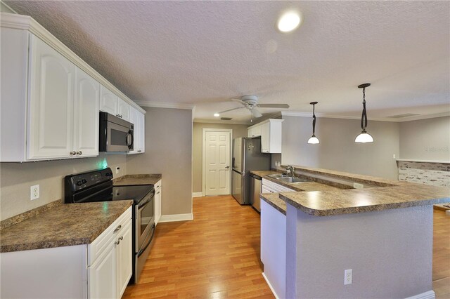 426 S Lakemont Ave, Winter Park, FL 32792 - kitchen with white cabinets, light wood finished floors, stainless steel appliances, dark countertops, and a ceiling fan