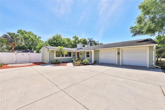 426 S Lakemont Ave, Winter Park, FL 32792 - ranch-style home with a gate, stucco siding, a garage, and concrete driveway