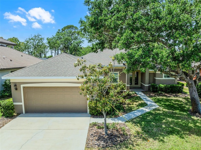 obstructed view of property featuring stucco siding, driveway, french doors, and a garage