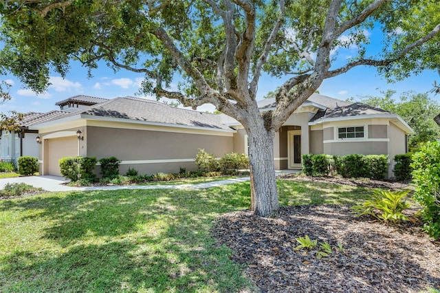 view of front of property with a front yard, a garage, stucco siding, and concrete driveway