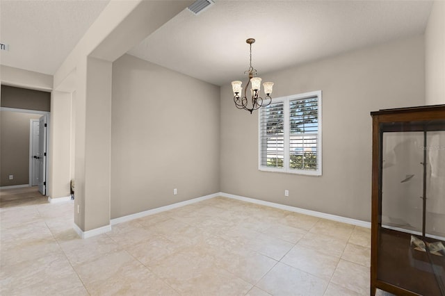 unfurnished dining area featuring light tile patterned floors, visible vents, a chandelier, and baseboards