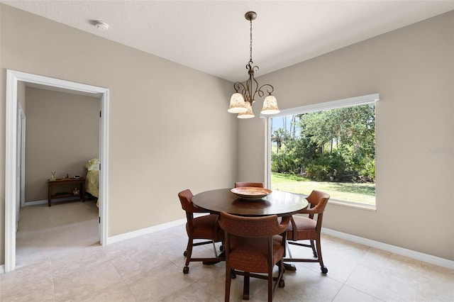 dining area featuring light tile patterned floors, a chandelier, and baseboards