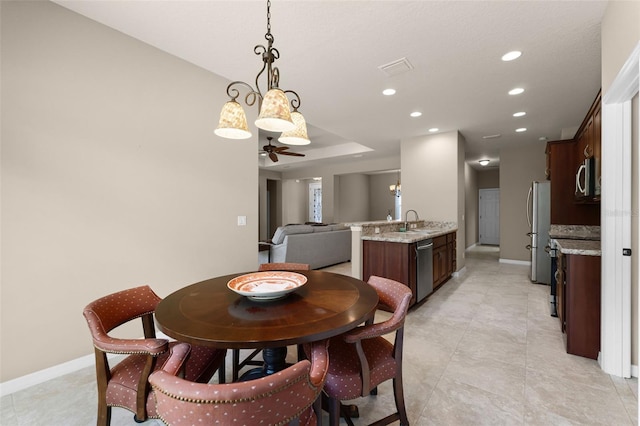 dining room with ceiling fan, recessed lighting, visible vents, and baseboards