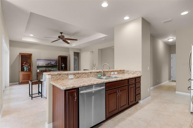 kitchen featuring a sink, light tile patterned floors, ceiling fan, a raised ceiling, and dishwasher