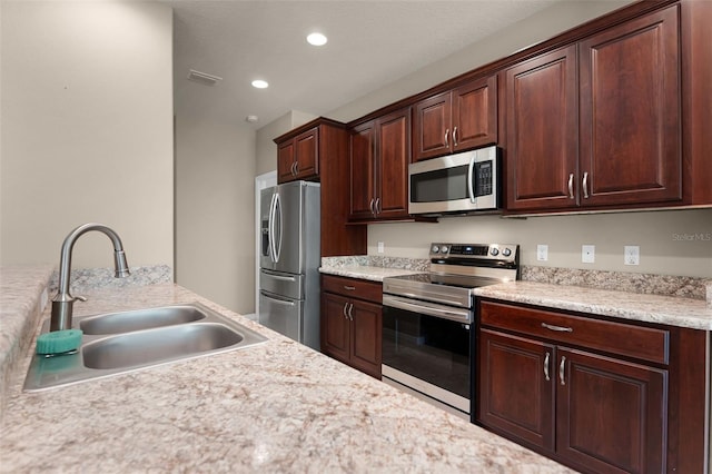 kitchen featuring a sink, appliances with stainless steel finishes, visible vents, light countertops, and recessed lighting