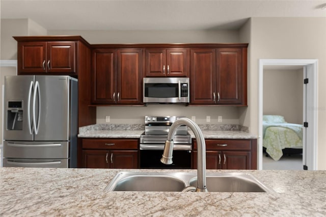 kitchen featuring a sink, appliances with stainless steel finishes, and light countertops