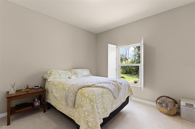 carpeted bedroom featuring baseboards