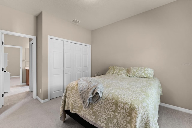 bedroom with baseboards, light carpet, and a closet