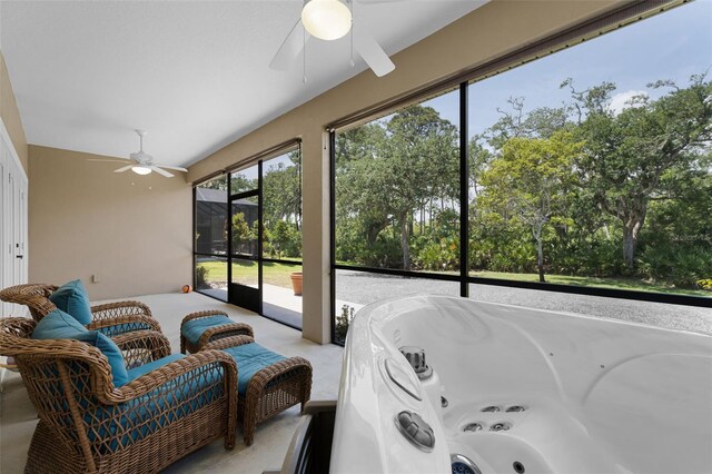 sunroom / solarium featuring ceiling fan