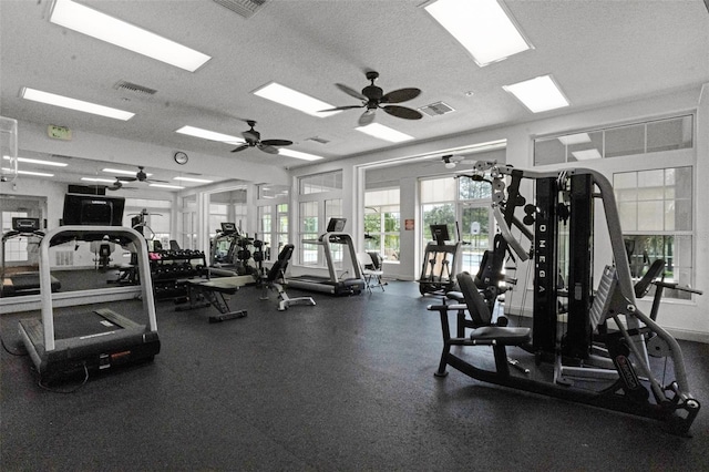 workout area featuring a textured ceiling, visible vents, and a ceiling fan