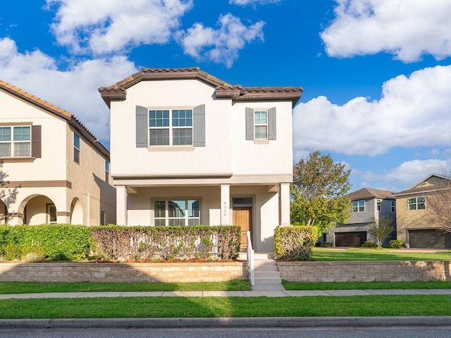 view of front of property with stucco siding and a tiled roof