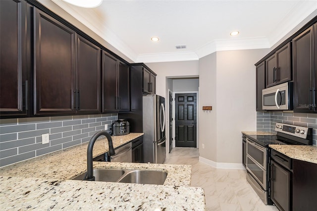 kitchen with light stone counters, a sink, stainless steel appliances, marble finish floor, and visible vents