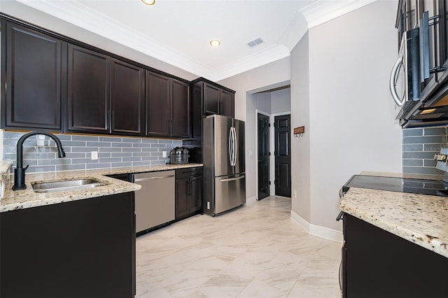 9330 Meadow Hunt Way, Winter Garden, FL 34787 - kitchen with stainless steel appliances, light stone counters, crown molding, backsplash, and light marble finish flooring