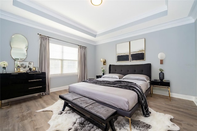 9330 Meadow Hunt Way, Winter Garden, FL 34787 - bedroom with a tray ceiling, crown molding, and light wood-style floors