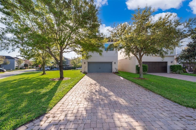 9330 Meadow Hunt Way, Winter Garden, FL 34787 - view of front of property featuring decorative driveway, a front lawn, a garage, and stucco siding