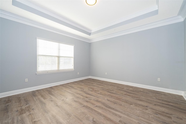 9330 Meadow Hunt Way, Winter Garden, FL 34787 - empty room with a raised ceiling, ornamental molding, and wood finished floors