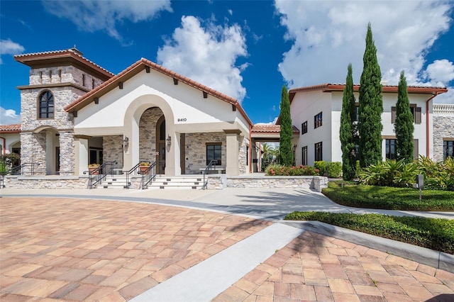 9330 Meadow Hunt Way, Winter Garden, FL 34787 - view of front of home featuring stucco siding, a tiled roof, and stone siding