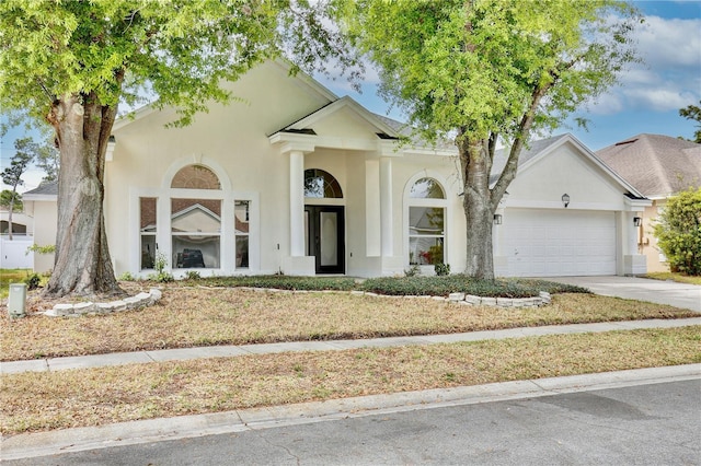 542 Terrace Cove Way, Orlando, FL 32828 - view of front of home featuring an attached garage, stucco siding, and driveway