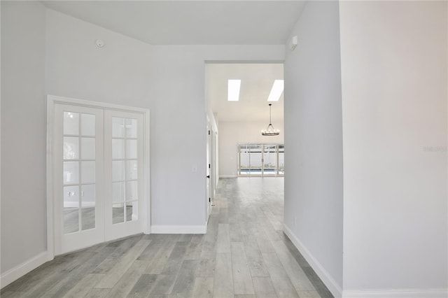 542 Terrace Cove Way, Orlando, FL 32828 - hall with baseboards, french doors, wood finished floors, and a chandelier