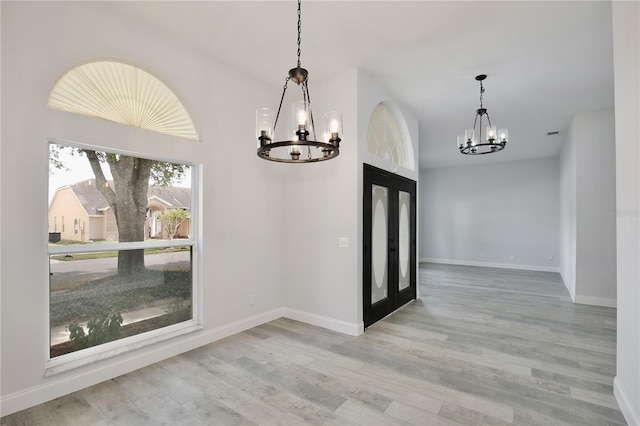 542 Terrace Cove Way, Orlando, FL 32828 - unfurnished dining area featuring lofted ceiling, baseboards, wood finished floors, and a chandelier