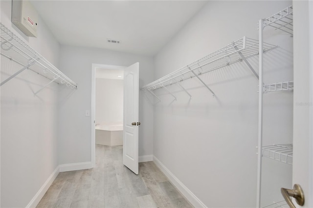 542 Terrace Cove Way, Orlando, FL 32828 - walk in closet with light wood-type flooring and visible vents