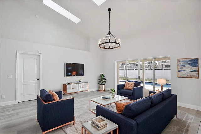 542 Terrace Cove Way, Orlando, FL 32828 - living room with baseboards, a high ceiling, a skylight, and an inviting chandelier