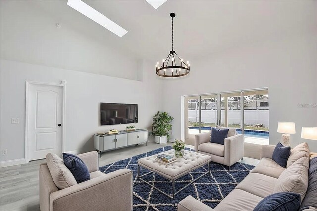 542 Terrace Cove Way, Orlando, FL 32828 - living area with a skylight, wood finished floors, a high ceiling, and a notable chandelier