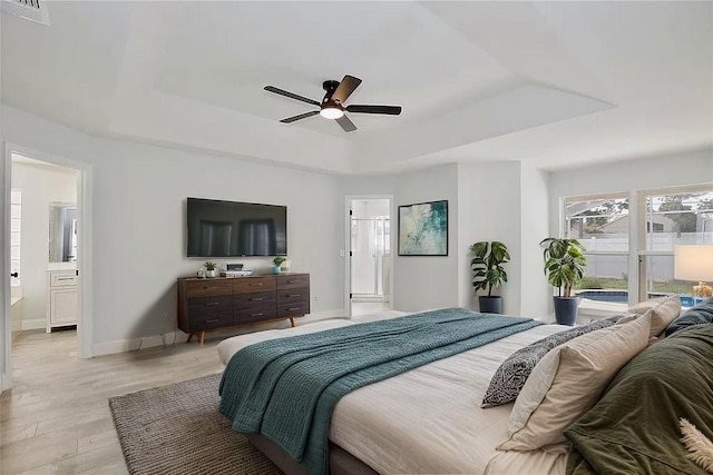 542 Terrace Cove Way, Orlando, FL 32828 - bedroom with a raised ceiling, visible vents, light wood-style floors, baseboards, and ensuite bathroom