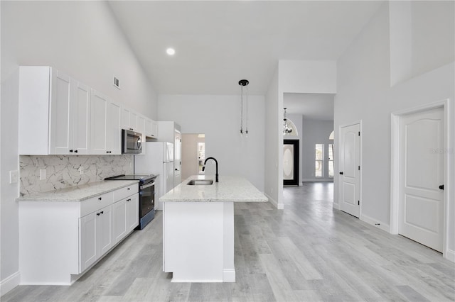 542 Terrace Cove Way, Orlando, FL 32828 - kitchen with range with electric stovetop, a sink, high vaulted ceiling, and stainless steel microwave