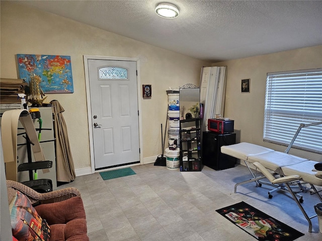 509 S Hudson St, Orlando, FL 32835 - foyer entrance featuring baseboards, lofted ceiling, light floors, and a textured ceiling