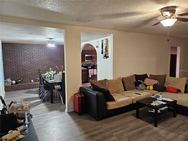 509 S Hudson St, Orlando, FL 32835 - living area with a textured ceiling, ceiling fan, visible vents, and wood finished floors
