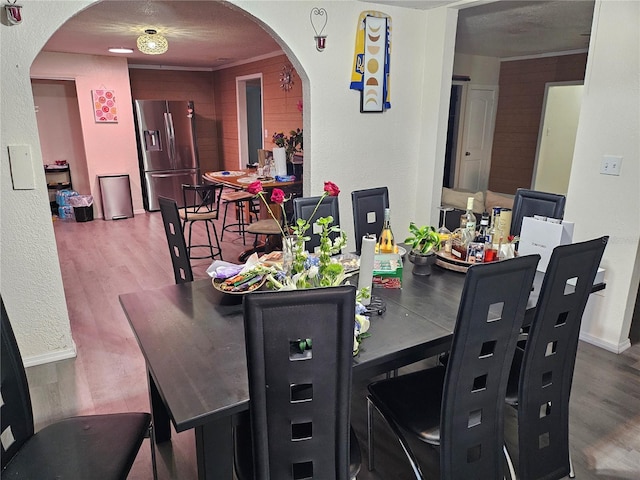 509 S Hudson St, Orlando, FL 32835 - dining room with arched walkways, baseboards, and wood finished floors