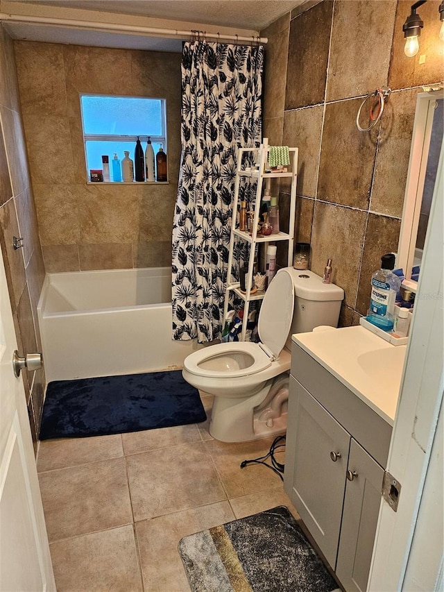 509 S Hudson St, Orlando, FL 32835 - full bath with tile patterned flooring, shower / bathtub combination with curtain, vanity, tile walls, and toilet