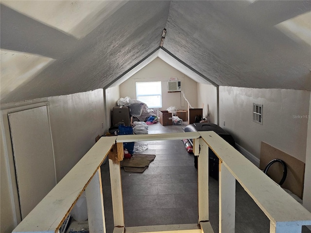 509 S Hudson St, Orlando, FL 32835 - bonus room featuring vaulted ceiling, a wall unit AC, and wood finished floors