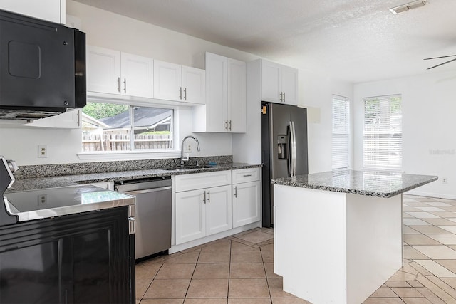 kitchen featuring visible vents, a sink, appliances with stainless steel finishes, and light tile patterned floors