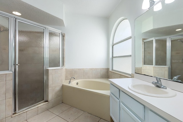 bathroom with vanity, tile patterned floors, a garden tub, and a stall shower