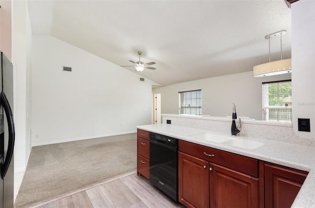 kitchen with vaulted ceiling, black appliances, light countertops, and a sink