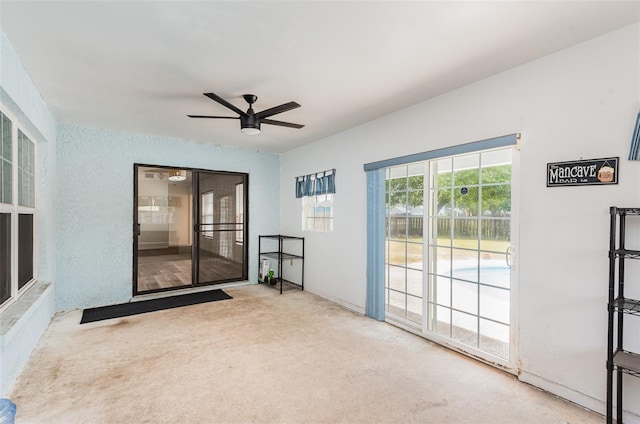 interior space with ceiling fan