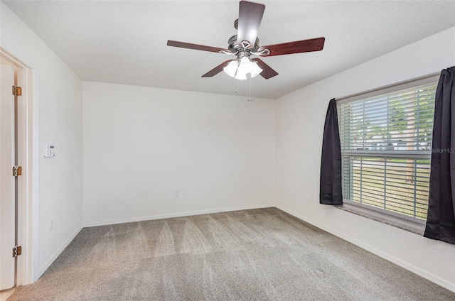 unfurnished room with baseboards, carpet floors, and ceiling fan