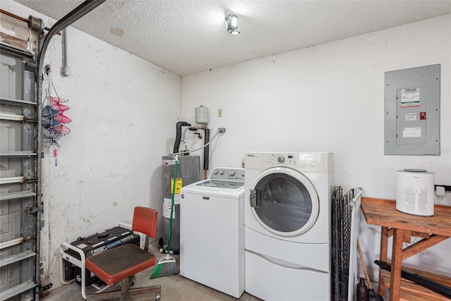 laundry room featuring water heater, a textured ceiling, washing machine and dryer, laundry area, and electric panel