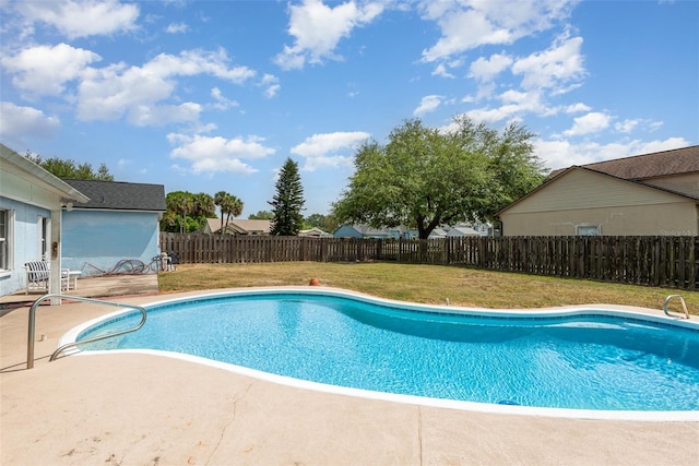 view of swimming pool with a fenced backyard, a fenced in pool, a yard, and a patio