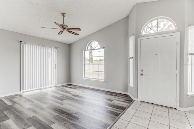 294 San Gabriel St, Winter Springs, FL 32708 - entryway with vaulted ceiling, a textured ceiling, light wood-type flooring, baseboards, and ceiling fan