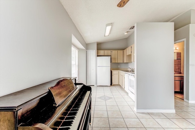 294 San Gabriel St, Winter Springs, FL 32708 - kitchen featuring light countertops, vaulted ceiling, light tile patterned floors, and white appliances
