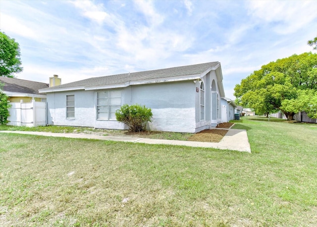 294 San Gabriel St, Winter Springs, FL 32708 - view of side of home with fence, stucco siding, and a yard